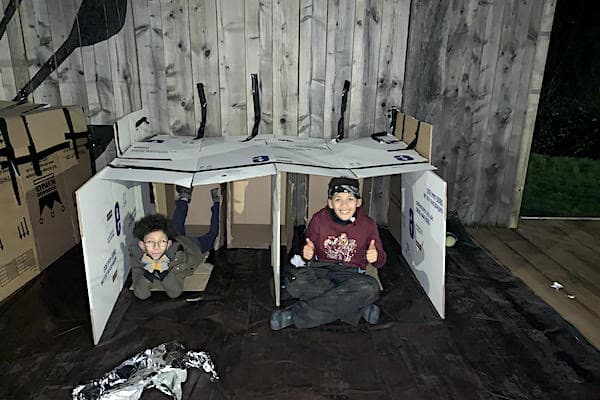 Angelo and his friend in the shelter they made for the night