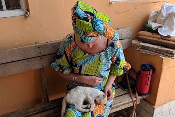 Cath and one of Ida’s kittens wearing traditional West African clothing, March 2018